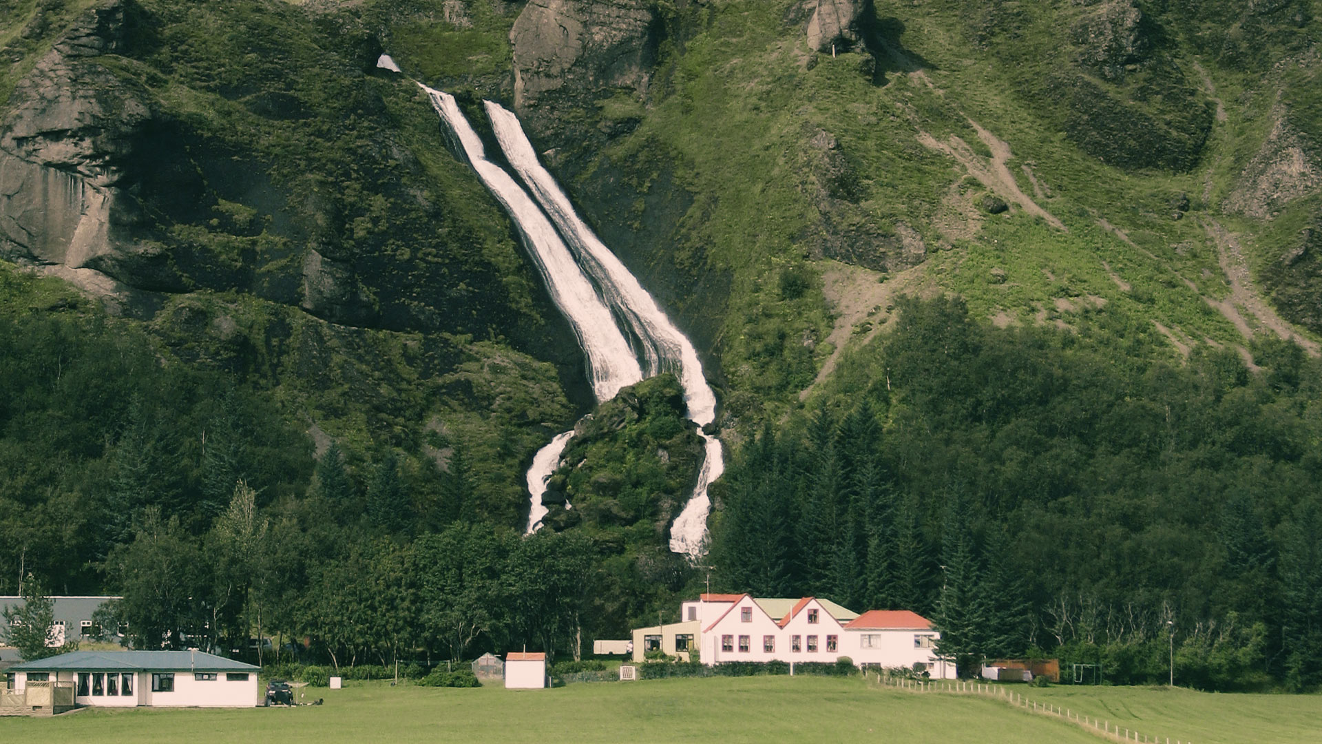 A waterfall and icelandic farm on the way to hrifunes nature park in the south of iceland